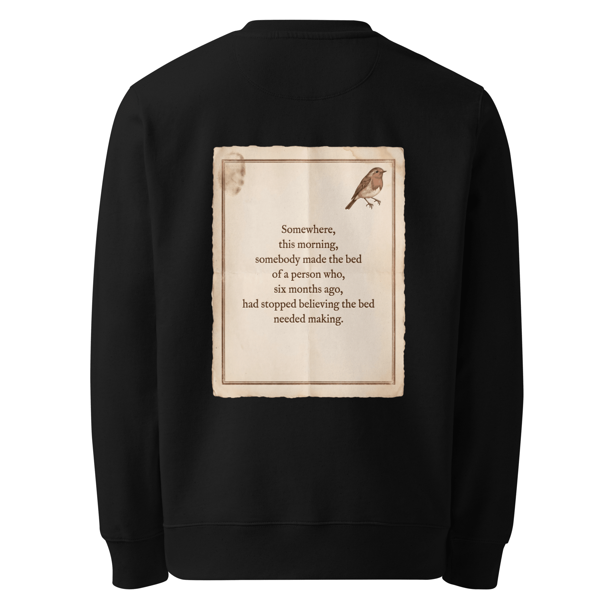 Made The Bed sweater, black — back view of aged paper slogan plate with robin, reading "Somewhere, this morning, somebody made the bed of a person who, six months ago, had stopped believing the bed needed making." — Ricki Robin