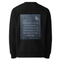 Set The Volume sweater, black — back view of slate slogan plate with key and robin, reading "You are not isolated. You are, finally, the only voice in the room that gets to set the volume on what comes next." — Ricki Robin