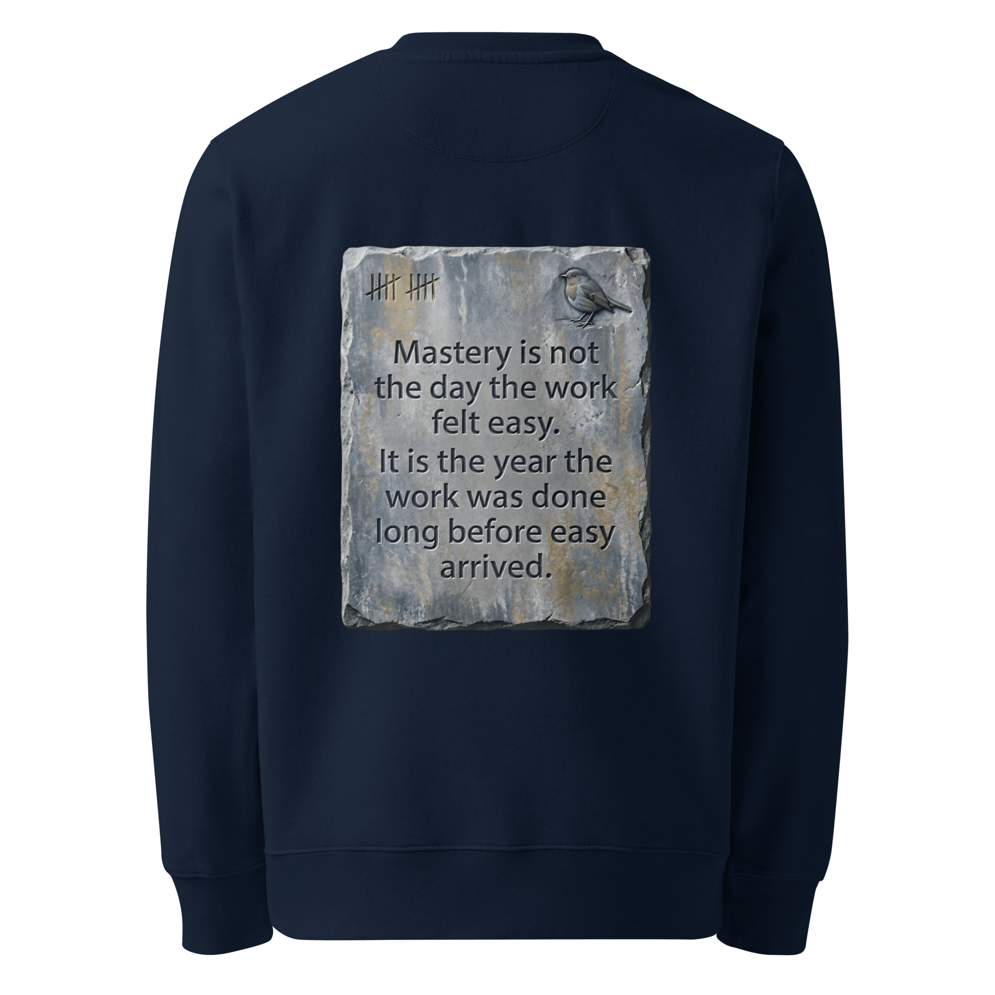 Long Before Easy sweater, French Navy — back view of worn metal slogan plate with robin, reading "Mastery is not the day the work felt easy. It is the year the work was done long before easy arrived." — Ricki Robin