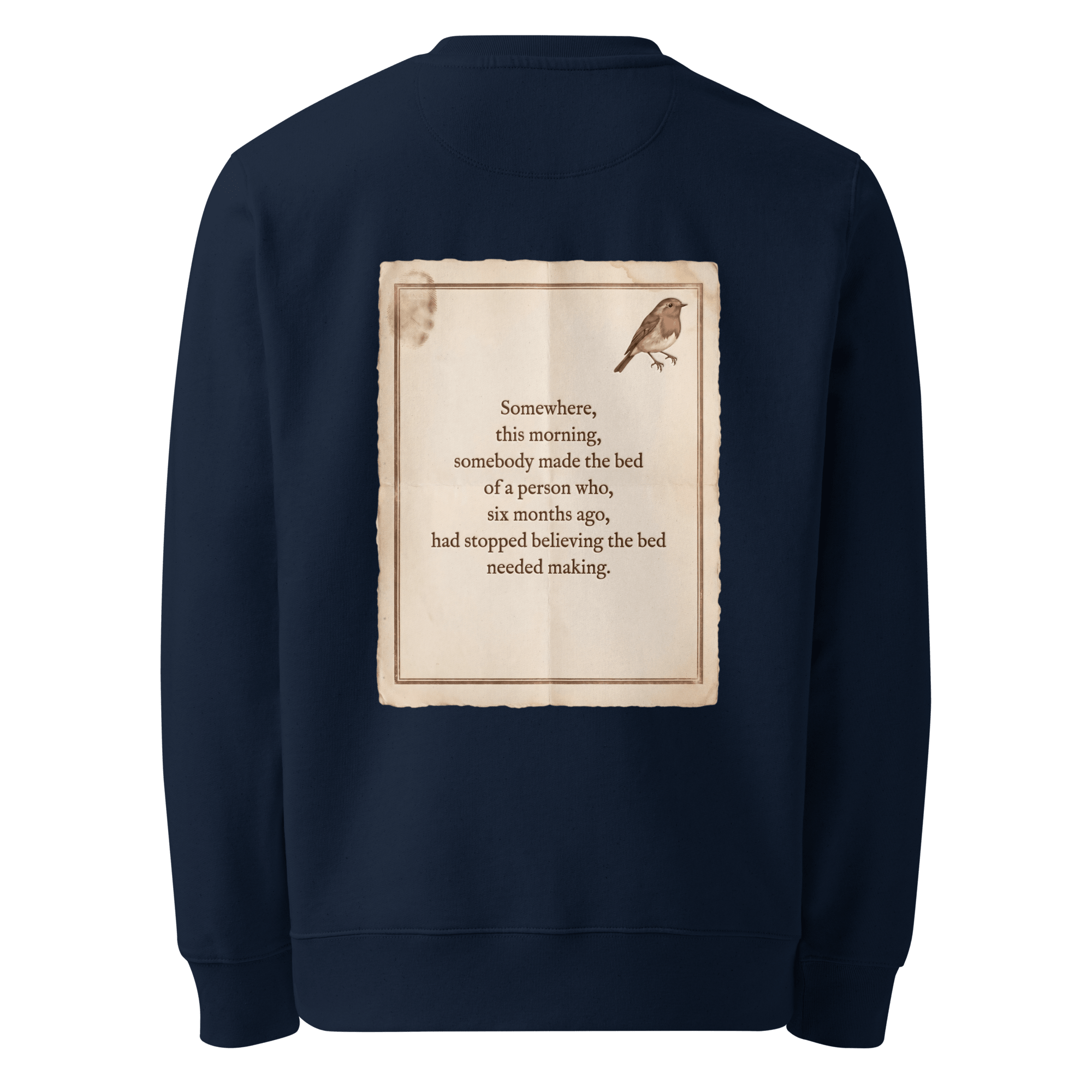 Made The Bed sweater, French Navy — back view of aged paper slogan plate with robin, reading "Somewhere, this morning, somebody made the bed of a person who, six months ago, had stopped believing the bed needed making." — Ricki Robin