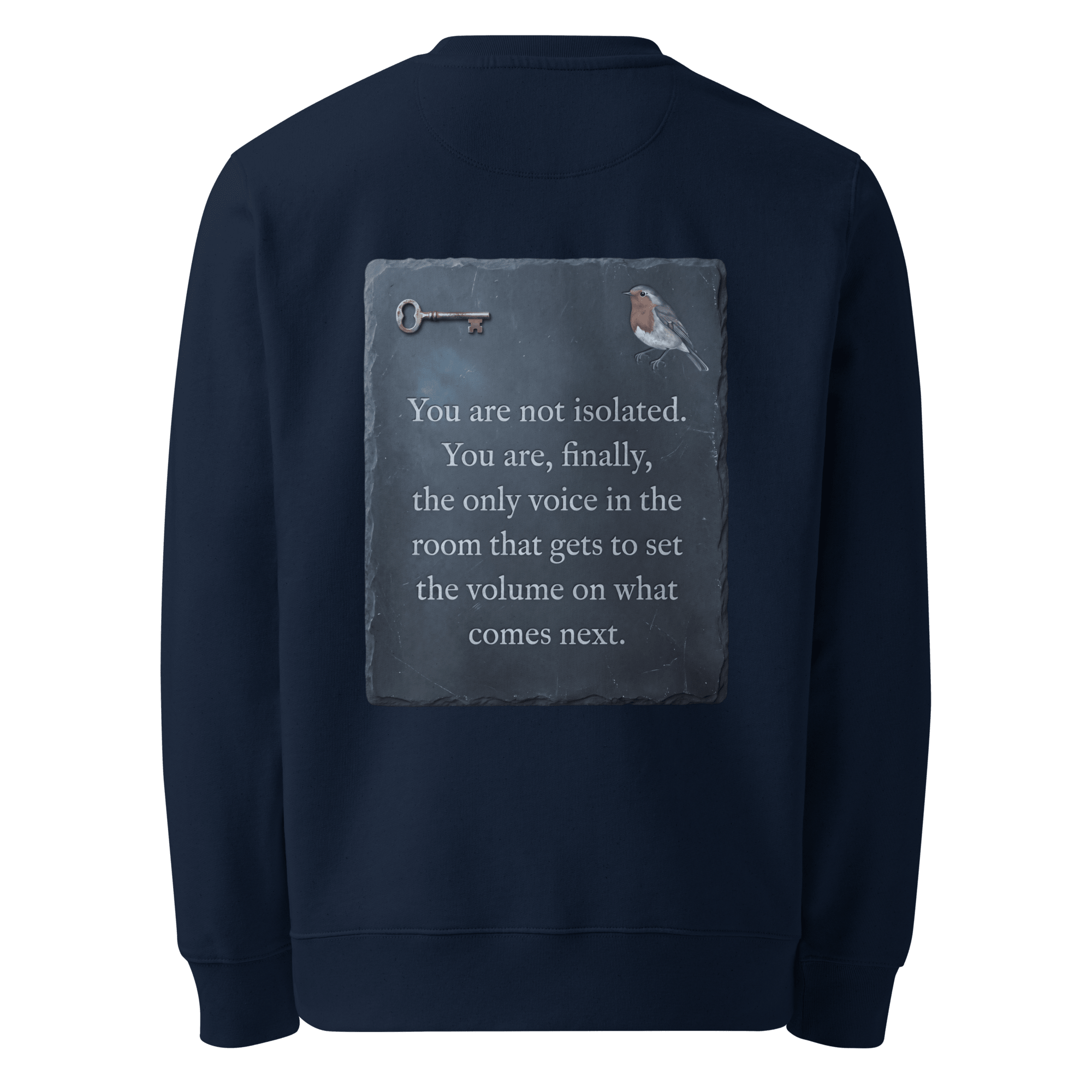 Set The Volume sweater, French Navy — back view of slate slogan plate with key and robin, reading "You are not isolated. You are, finally, the only voice in the room that gets to set the volume on what comes next." — Ricki Robin