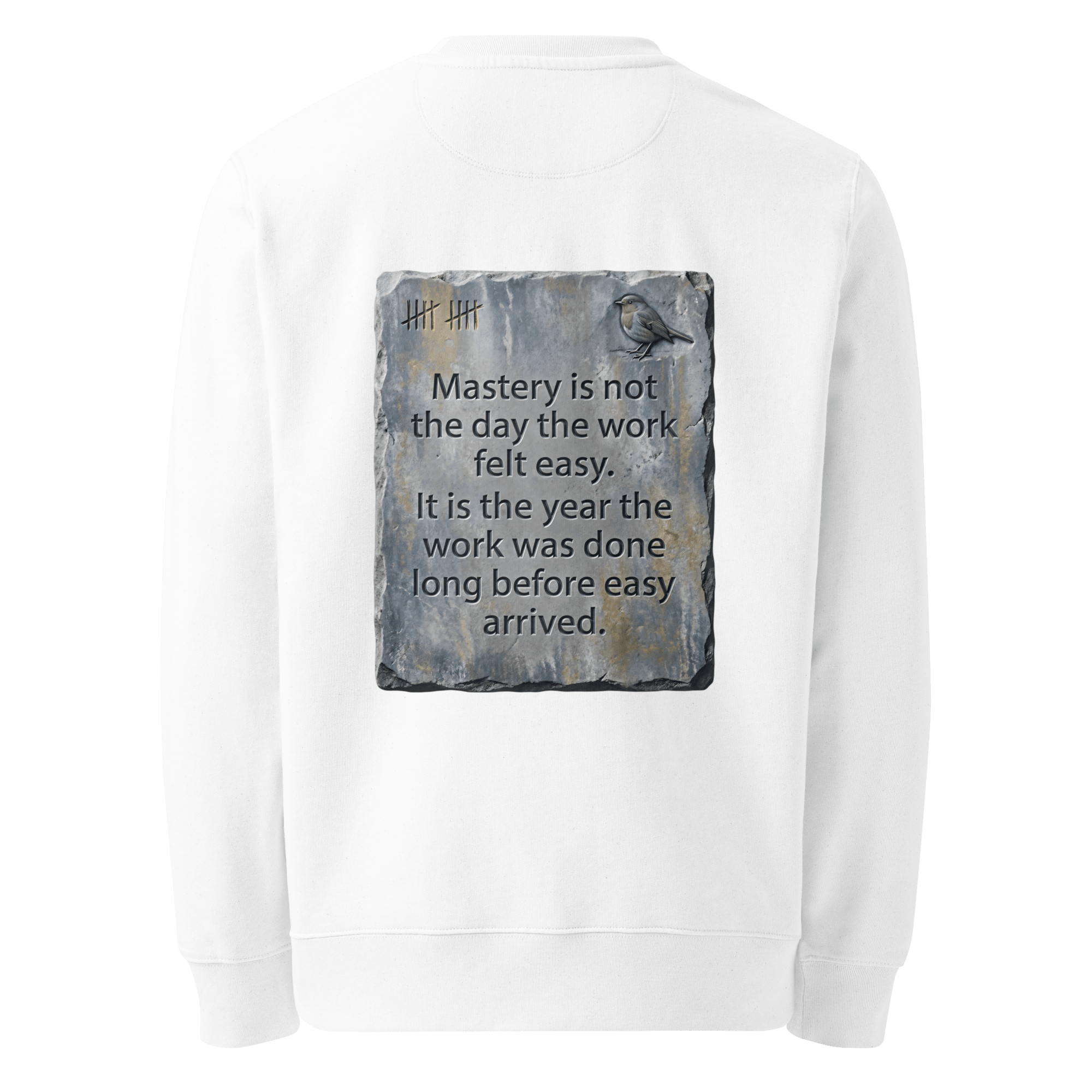 Long Before Easy sweater, white — back view of worn metal slogan plate with robin, reading "Mastery is not the day the work felt easy. It is the year the work was done long before easy arrived." — Ricki Robin