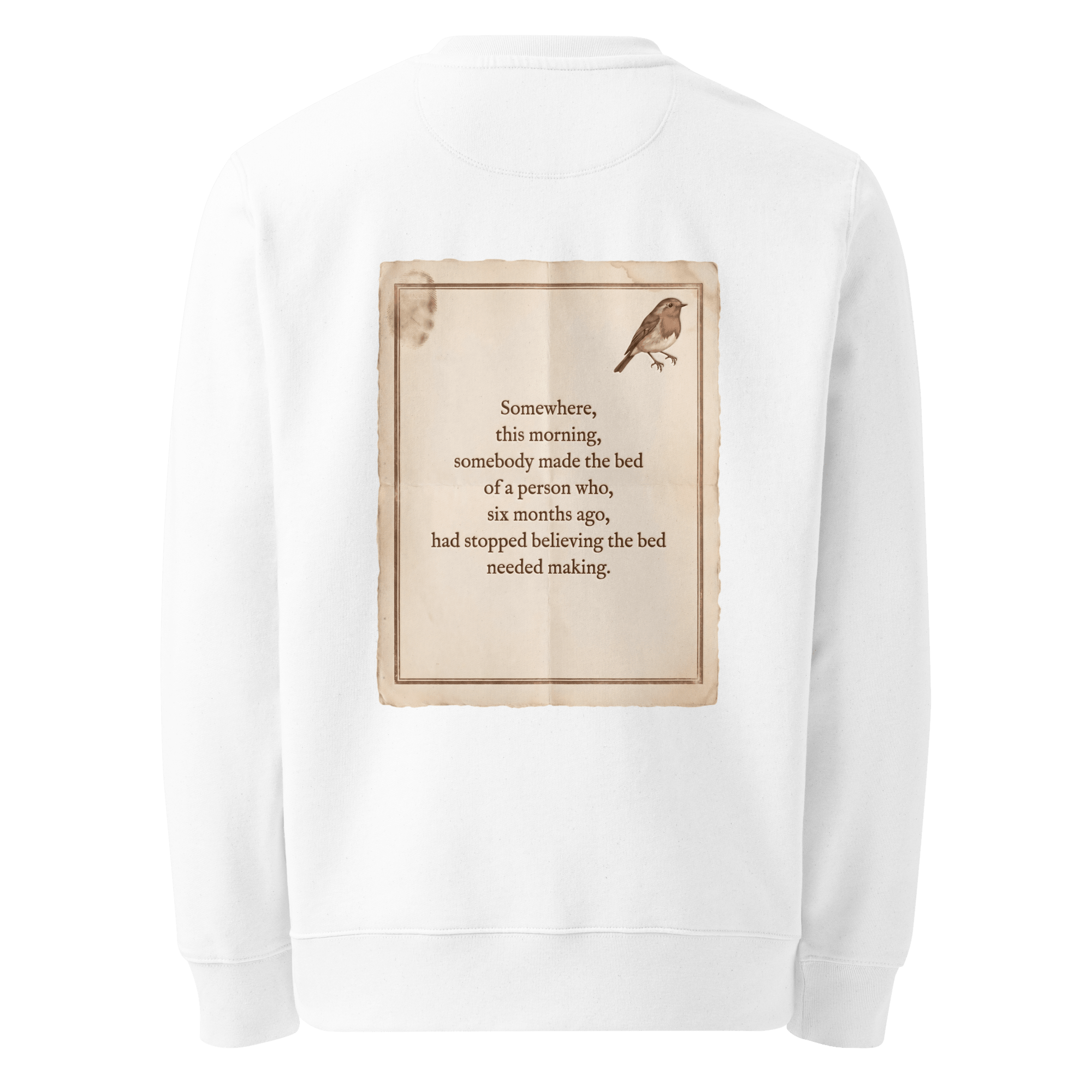 Made The Bed sweater, white — back view of aged paper slogan plate with robin, reading "Somewhere, this morning, somebody made the bed of a person who, six months ago, had stopped believing the bed needed making." — Ricki Robin