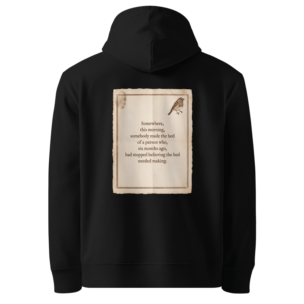 Made The Bed hoodie, black — back view of aged paper slogan plate with robin, reading "Somewhere, this morning, somebody made the bed of a person who, six months ago, had stopped believing the bed needed making." — Ricki Robin