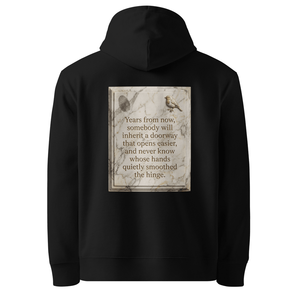 Quietly Smoothed hoodie, black — back view of marble slogan plate with fingerprint and robin, reading "Years from now, somebody will inherit a doorway that opens easier, and never know whose hands quietly smoothed the hinge." — Ricki Robin