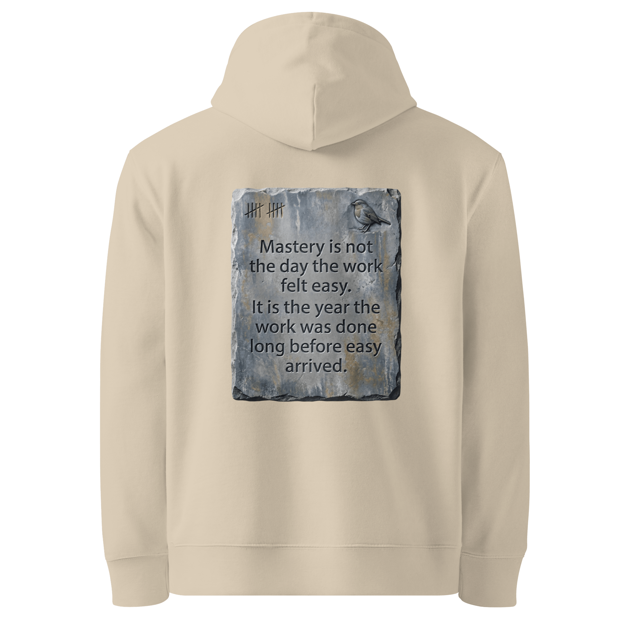 Long Before Easy hoodie, Desert Dust — back view of worn metal slogan plate with robin, reading "Mastery is not the day the work felt easy. It is the year the work was done long before easy arrived." — Ricki Robin