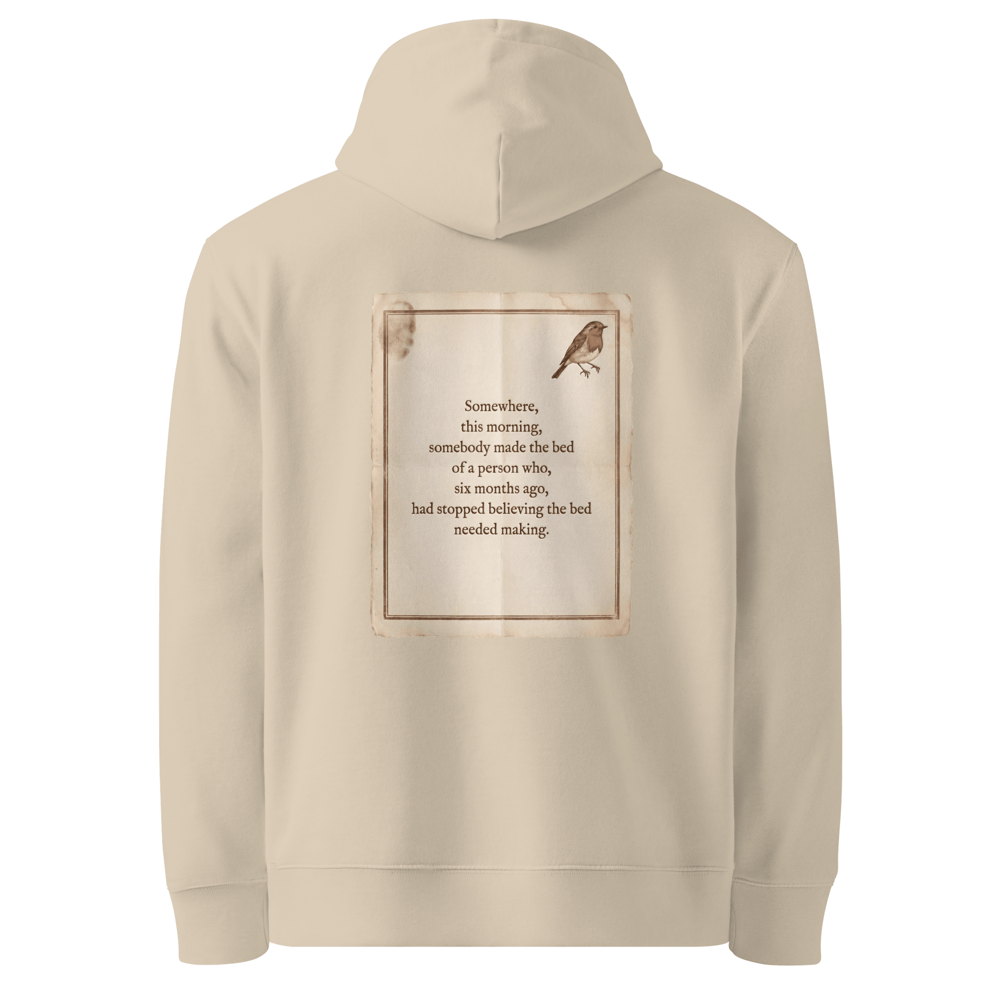 Made The Bed hoodie, Desert Dust — back view of aged paper slogan plate with robin, reading "Somewhere, this morning, somebody made the bed of a person who, six months ago, had stopped believing the bed needed making." — Ricki Robin